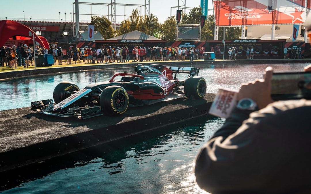 Formula 1 car driving on a wet track surface