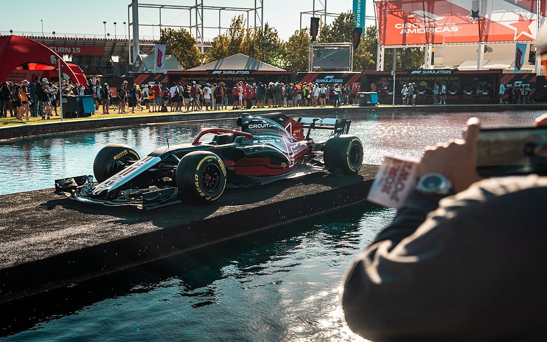 Formula 1 car driving on a wet track surface