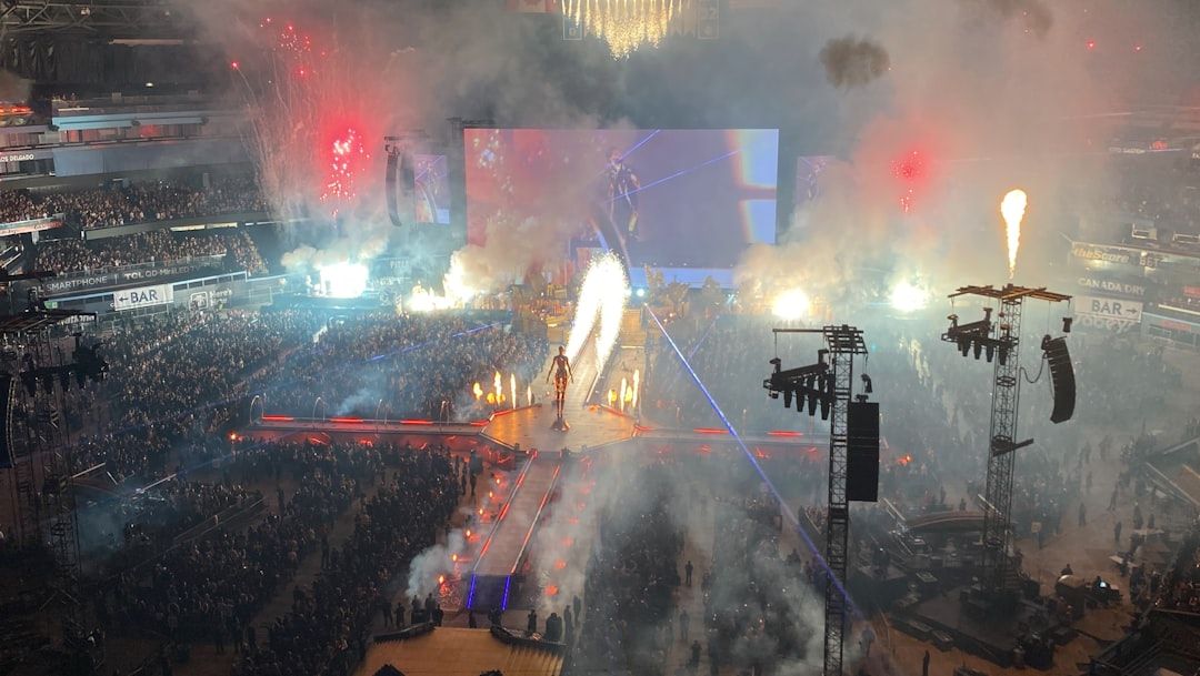 Concert stage with pyrotechnics and a large crowd at night