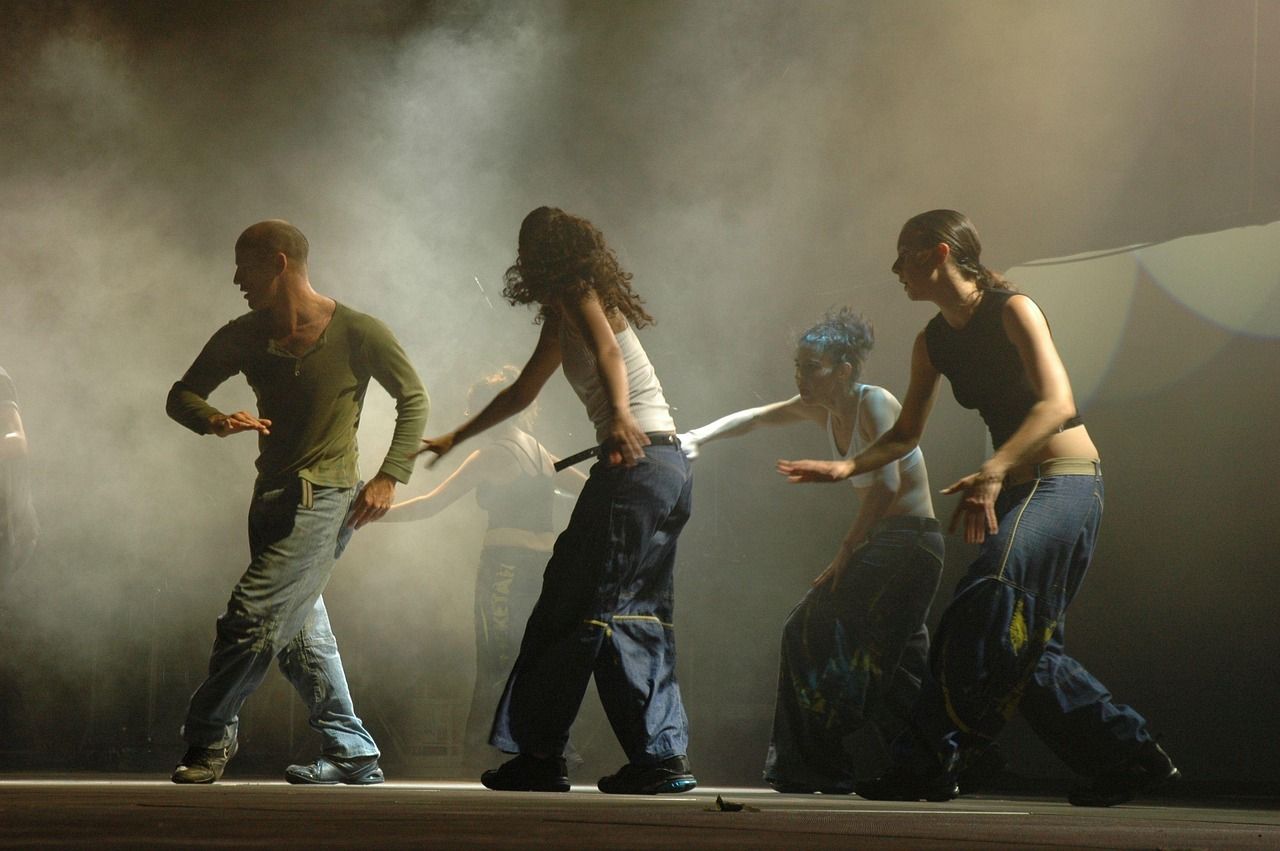 Dramatic stage performance with spotlight and smoke effects