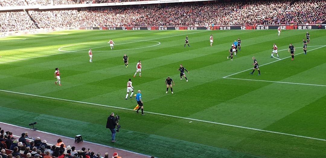 Football match action in a Premier League stadium
