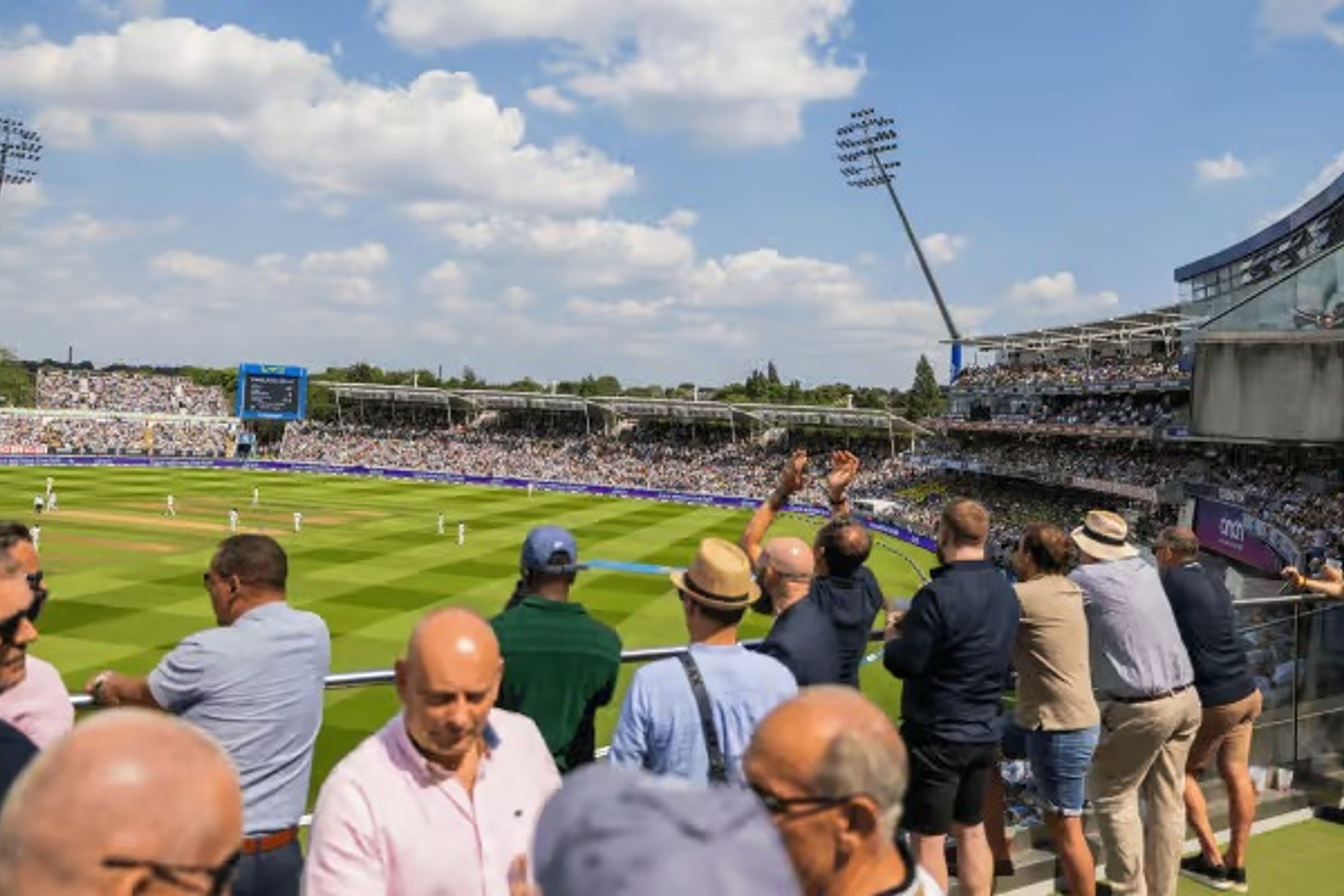 A cricket match seen from the pavilion