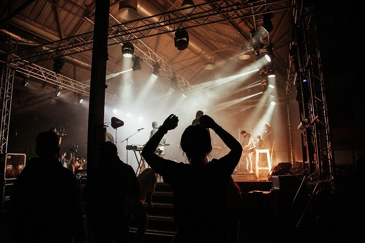 Arena concert with crowd and dramatic stage production
