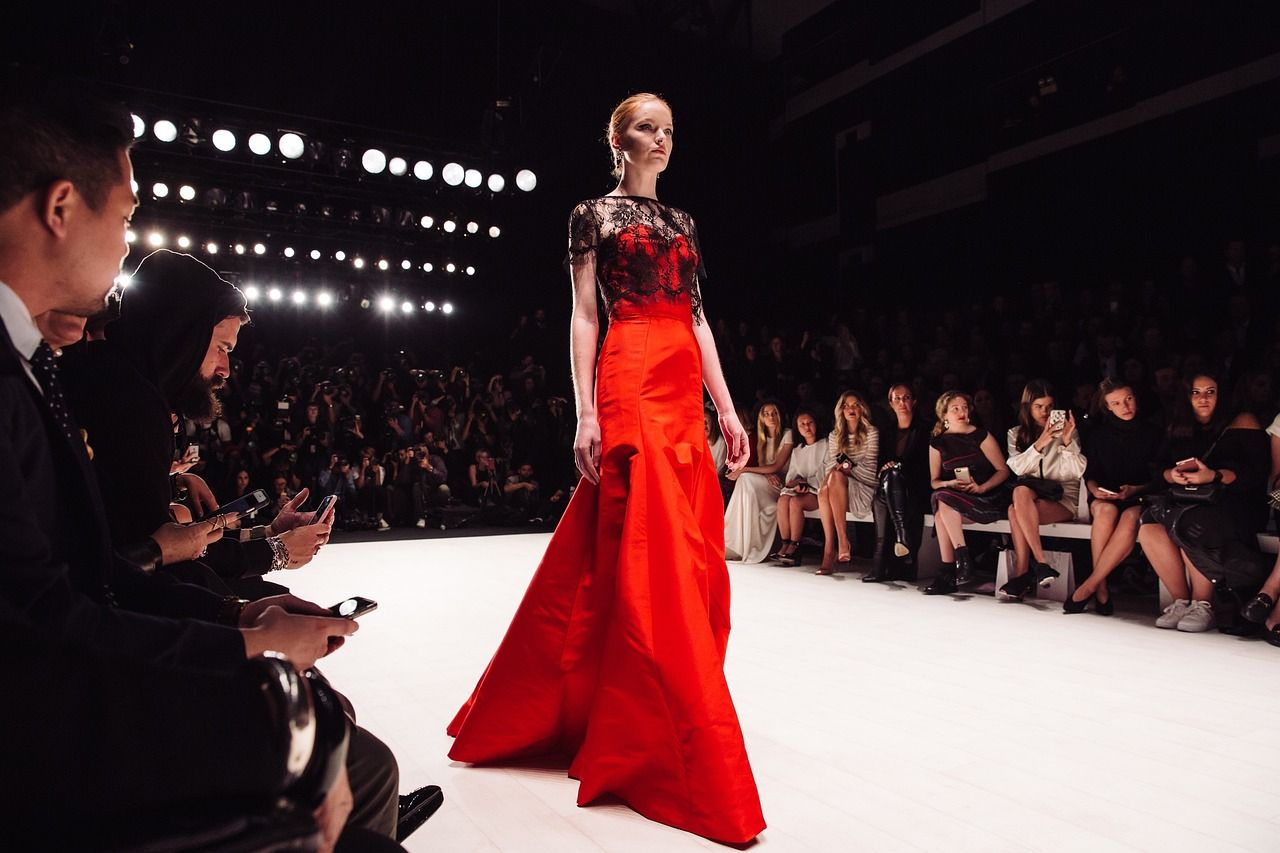 Fashion runway show under spotlights, reflecting the glamour of The Devil Wears Prada musical