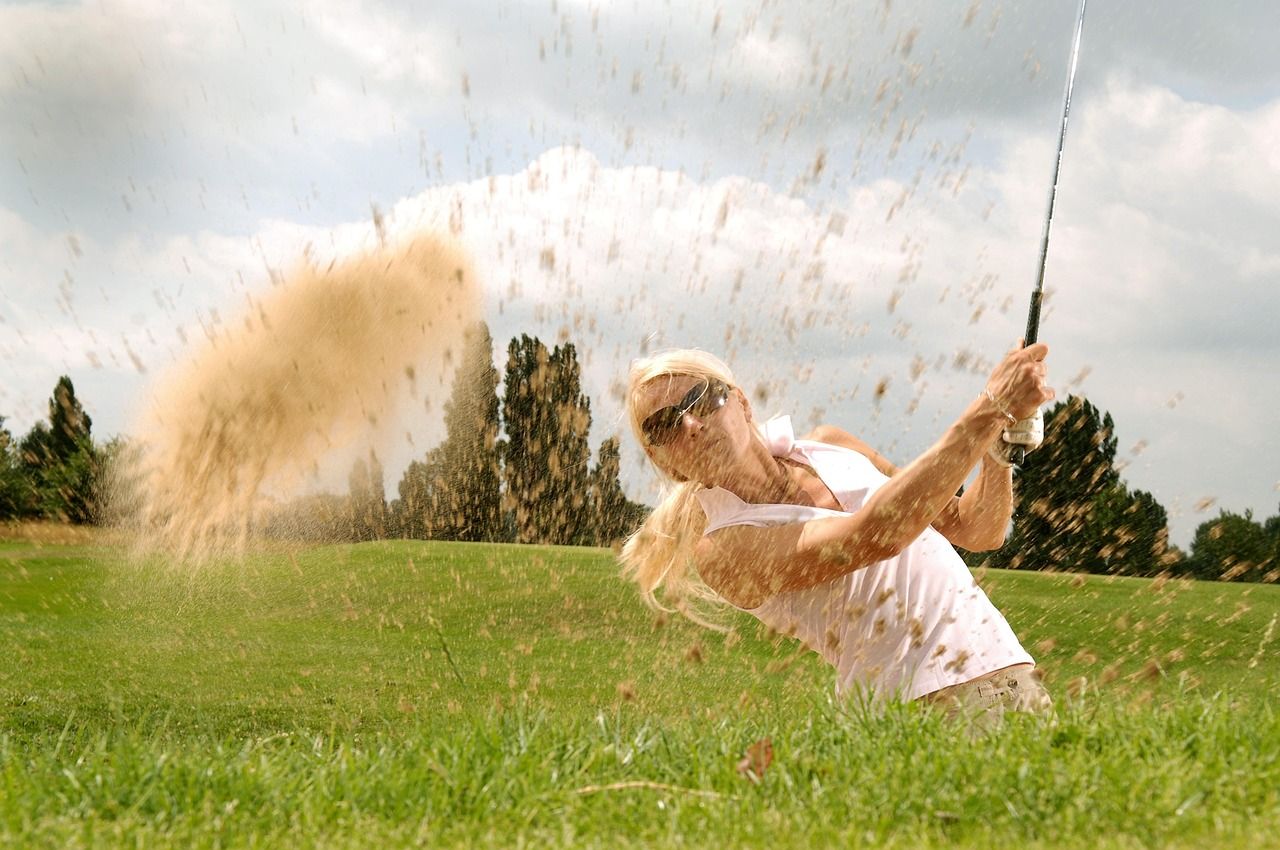Golfer playing a bunker shot, evoking the recovery of Jersey's courses after wartime damage