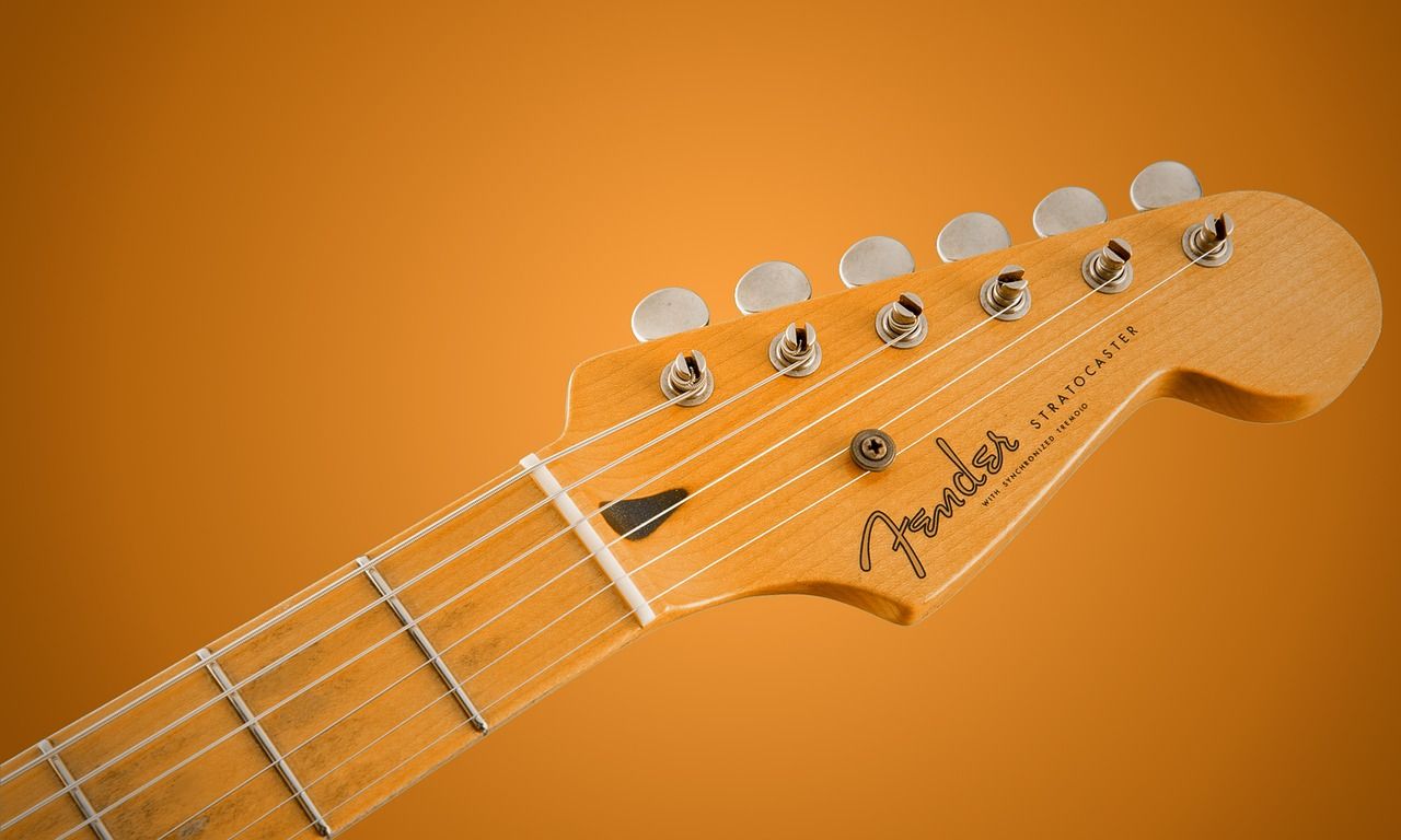 Close-up of an electric guitar in warm orange tones