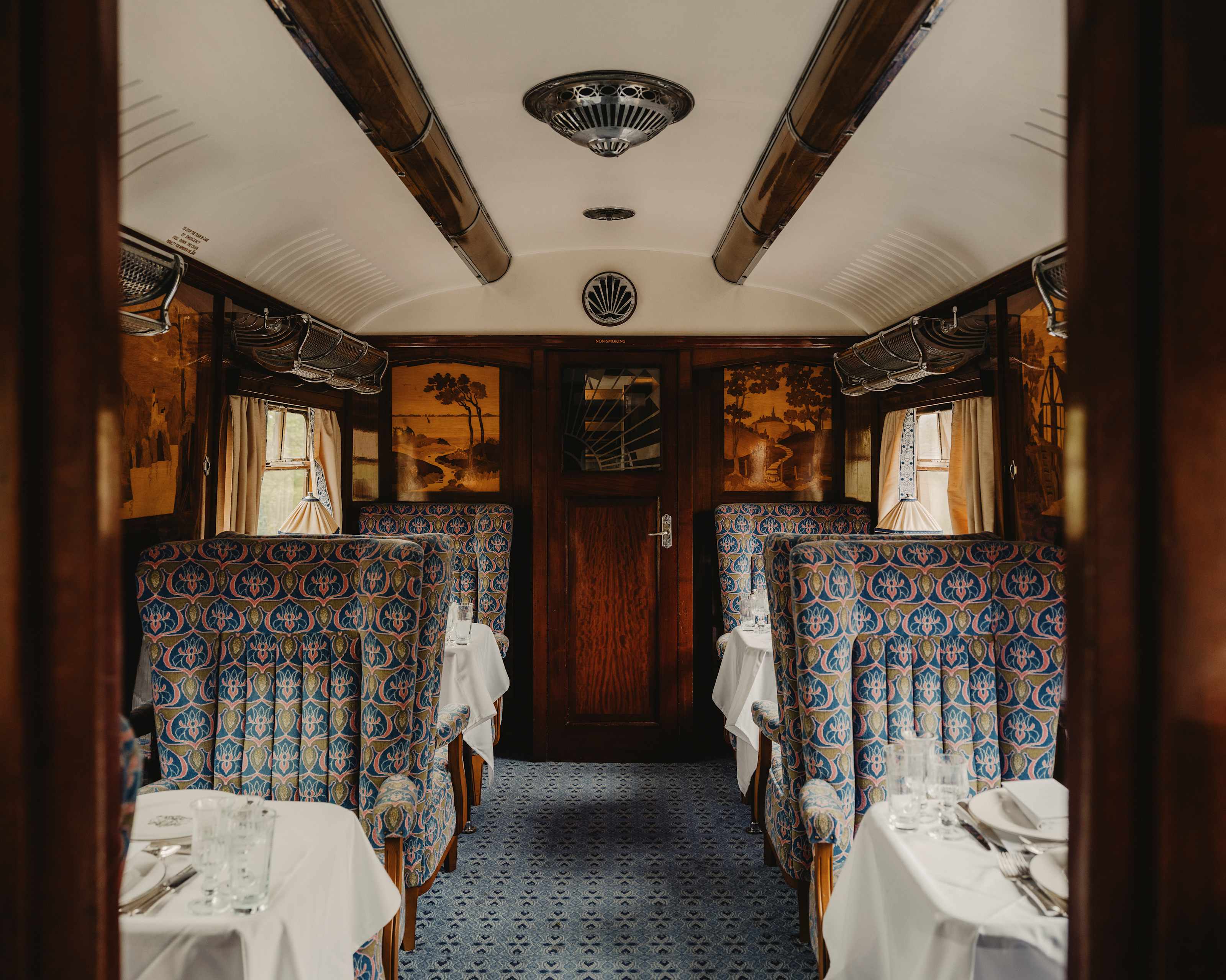 Carriage interior with patterned armchairs and marquetry panels