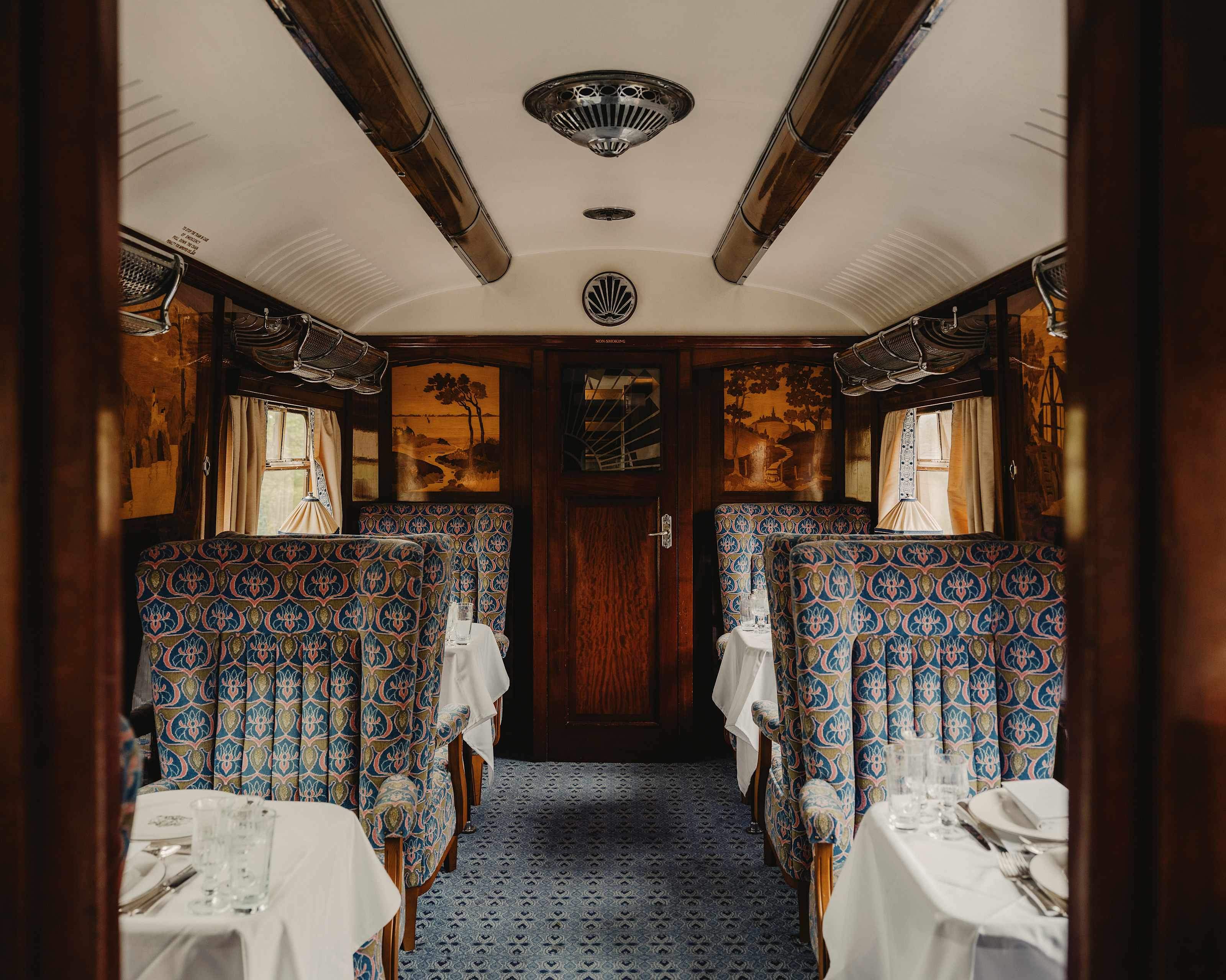 Carriage interior with patterned armchairs and marquetry panels