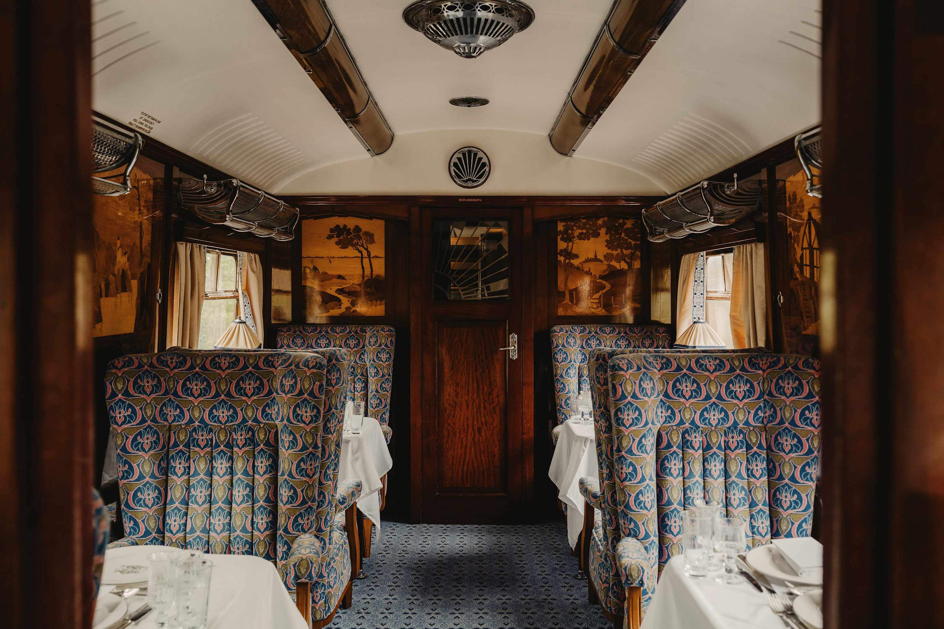 Carriage interior with patterned armchairs and marquetry panels