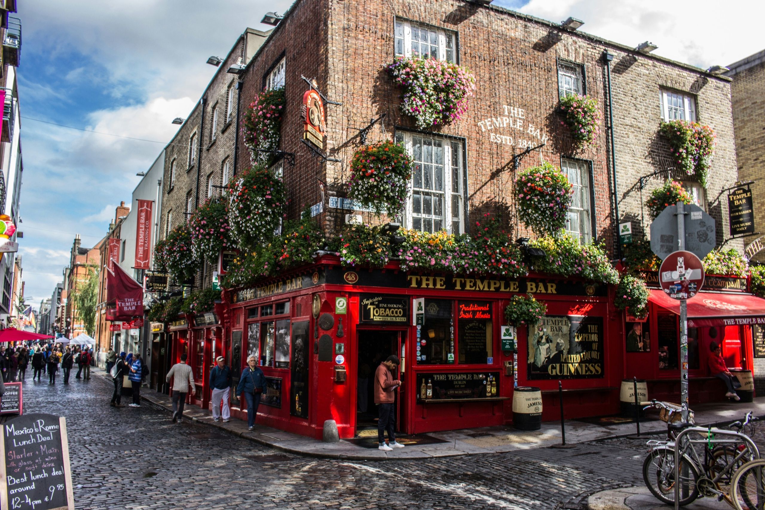 The Temple Bar pub on a cobbled corner in Dublin, its red frontage hung with flower baskets