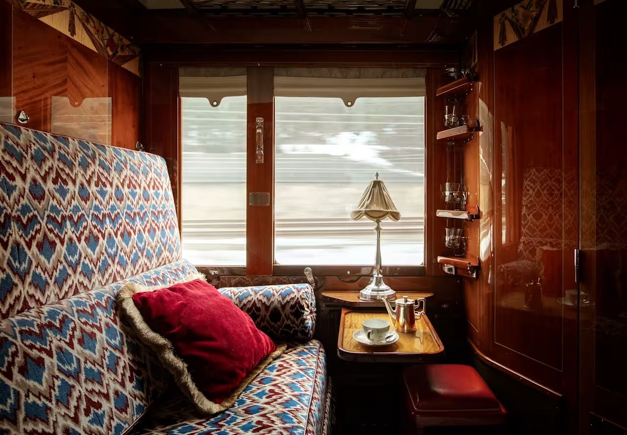 A historic cabin aboard the Venice Simplon-Orient-Express with rich wood panelling and period details