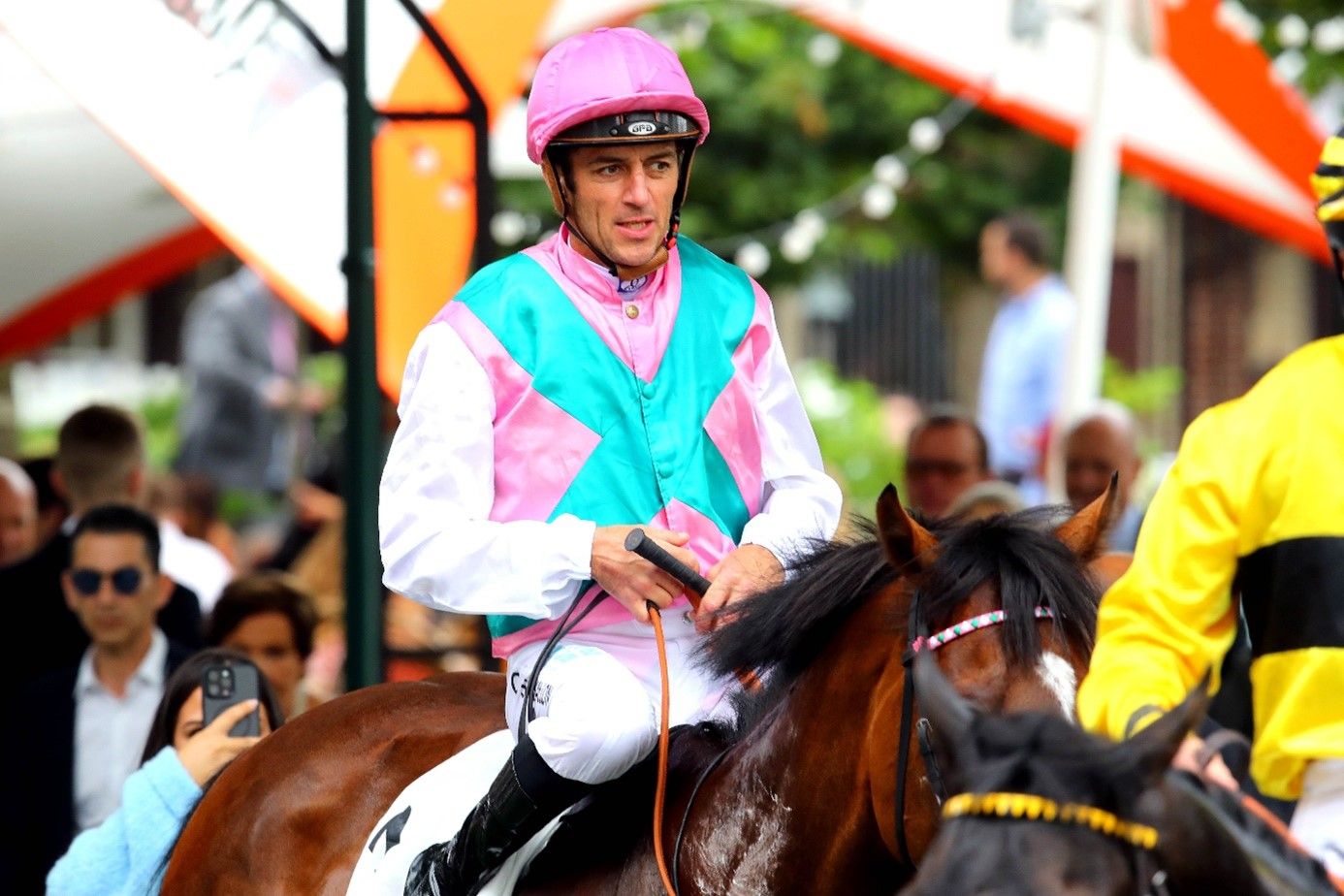 Close-up of a racehorse and jockey in full stride