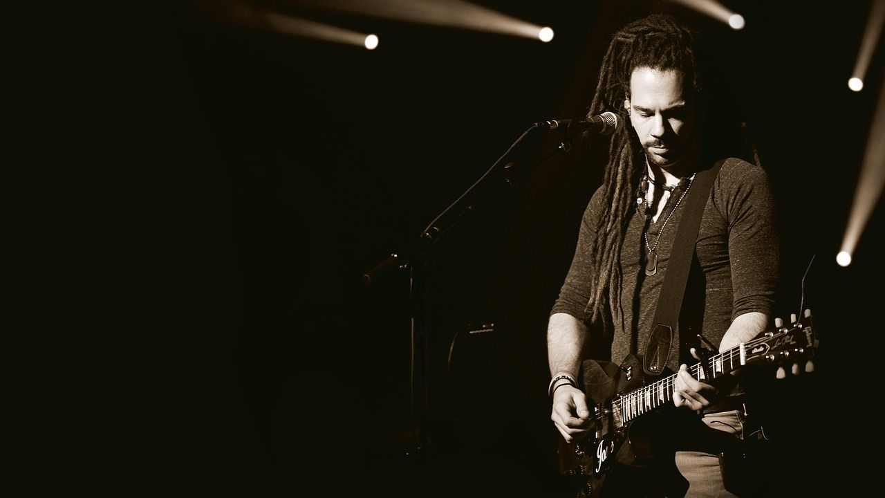 Singer-guitarist performing in monochrome concert setting