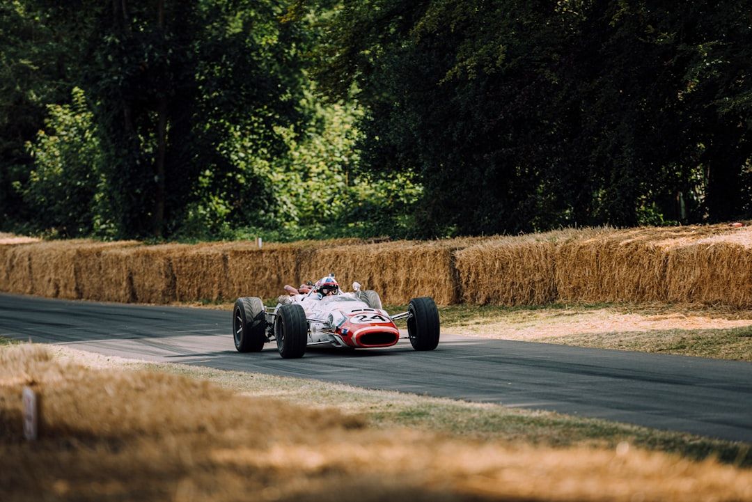 Classic open-wheel racing car on a circuit, reminiscent of mid-century grand prix racing