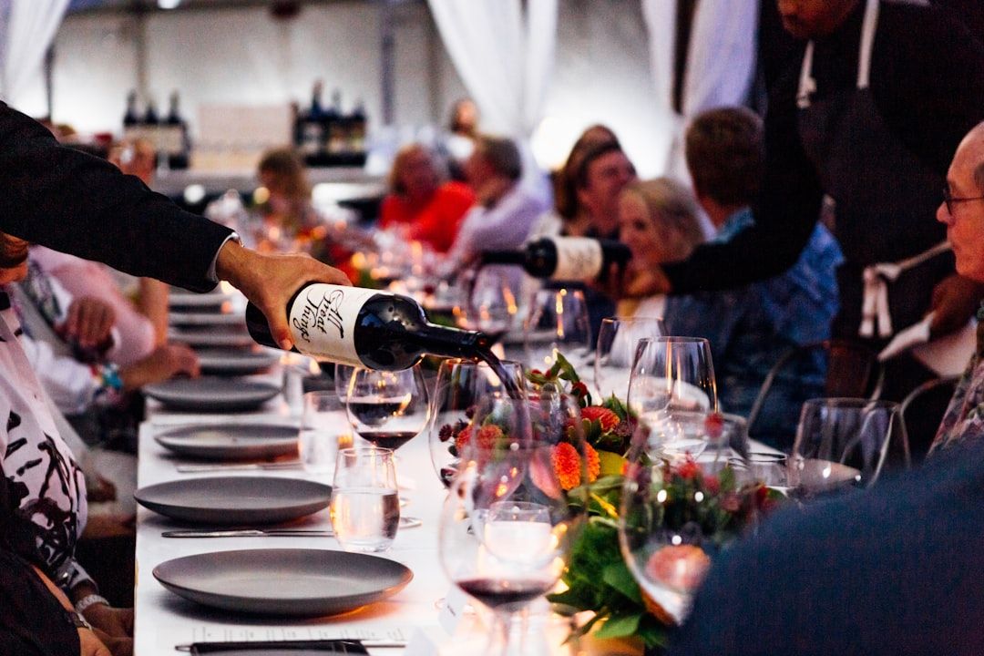 Guests seated around a table at a wine tasting dinner event