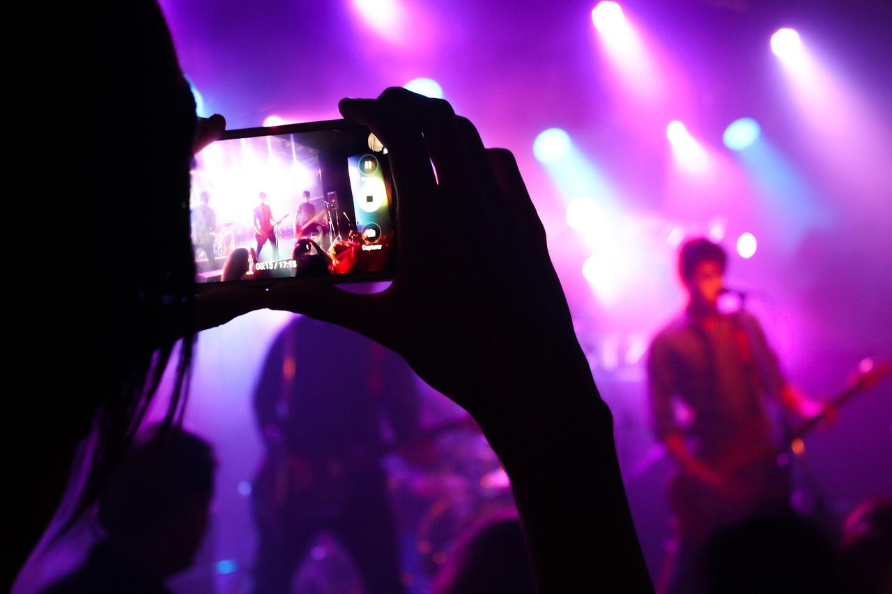Live music performance on stage with dramatic lighting