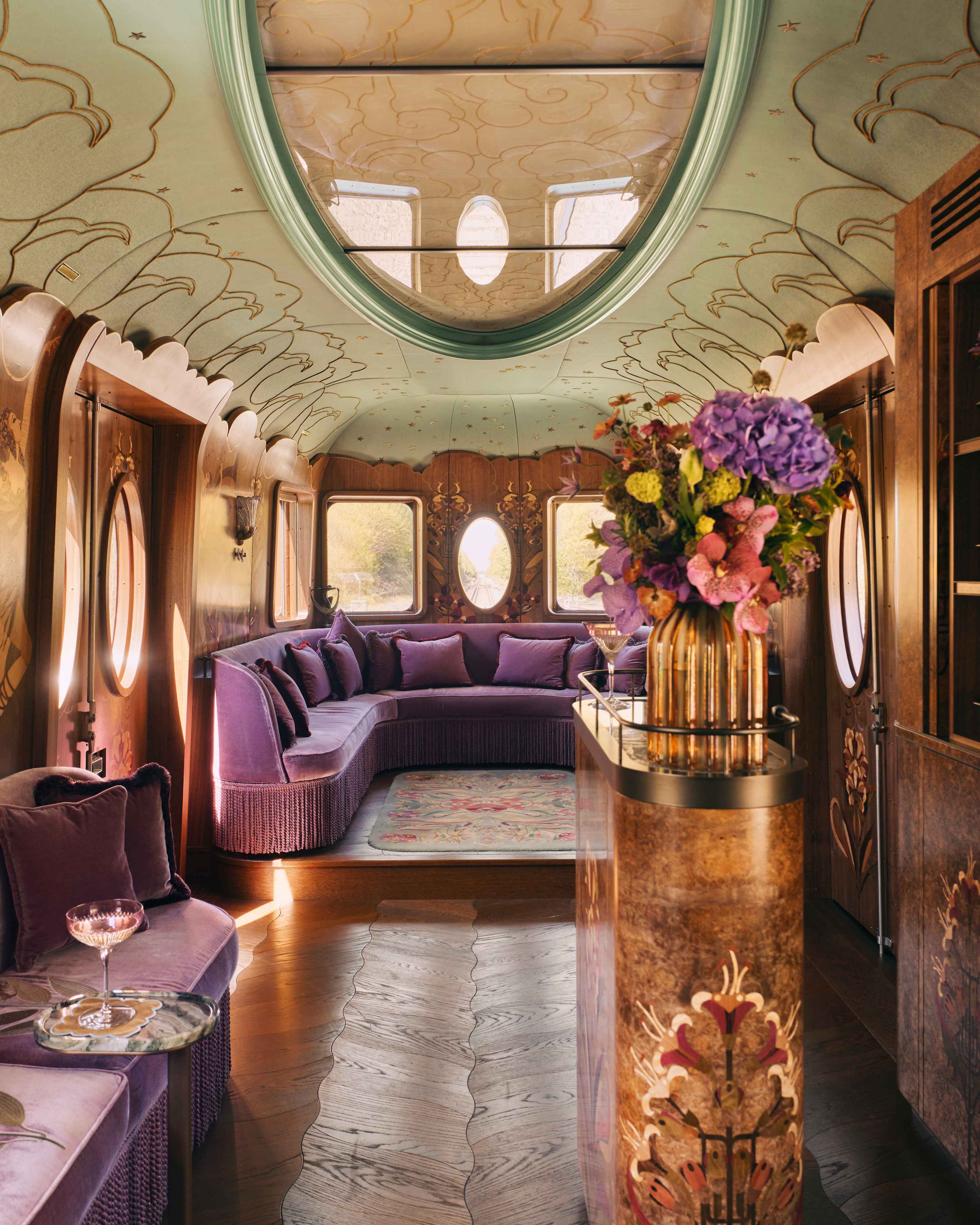 The Celia carriage with its curved velvet sofa, cocktail bar and painted ceiling