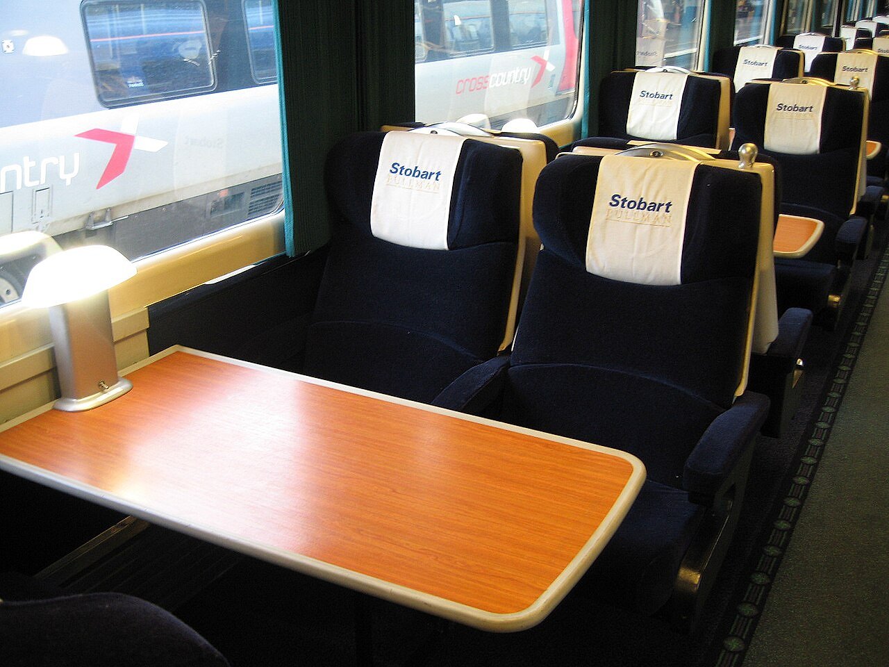 First Class Pullman-style train carriage interior with elegant table settings