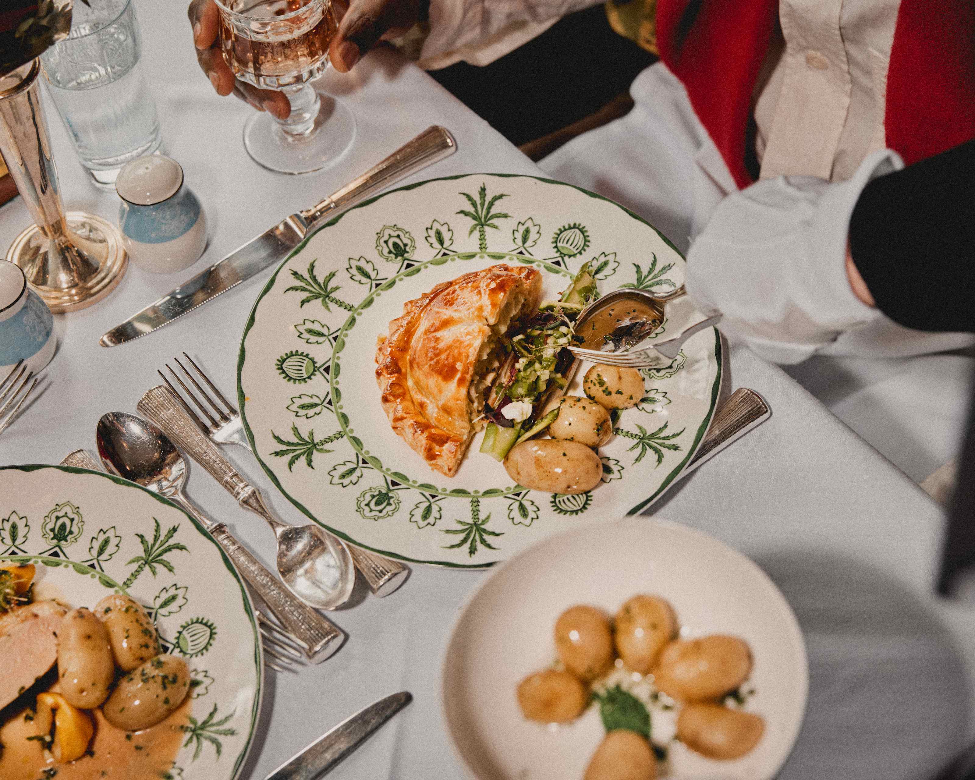Plated courses being served at a laid table on board