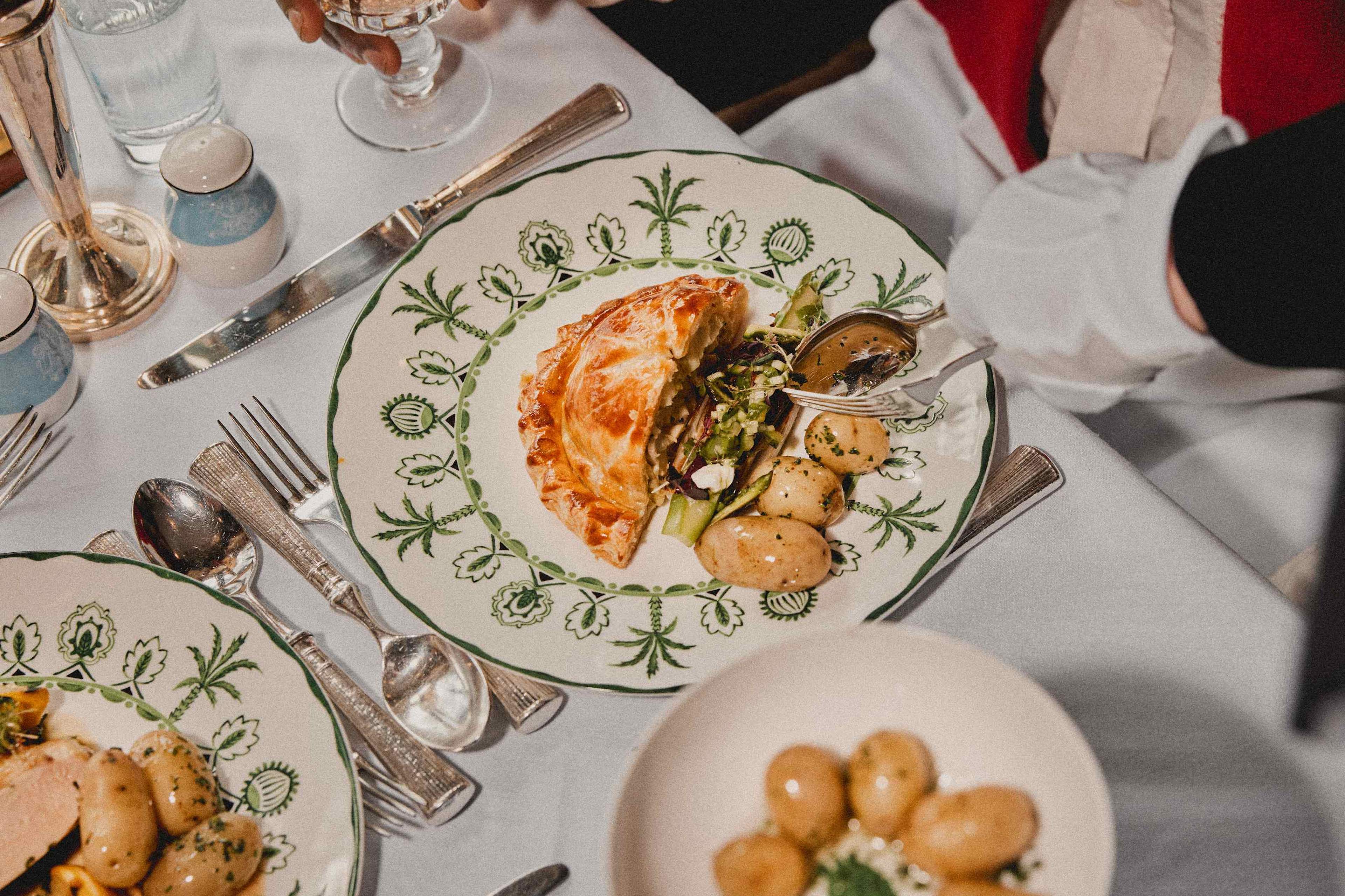 Plated courses being served at a laid table on board