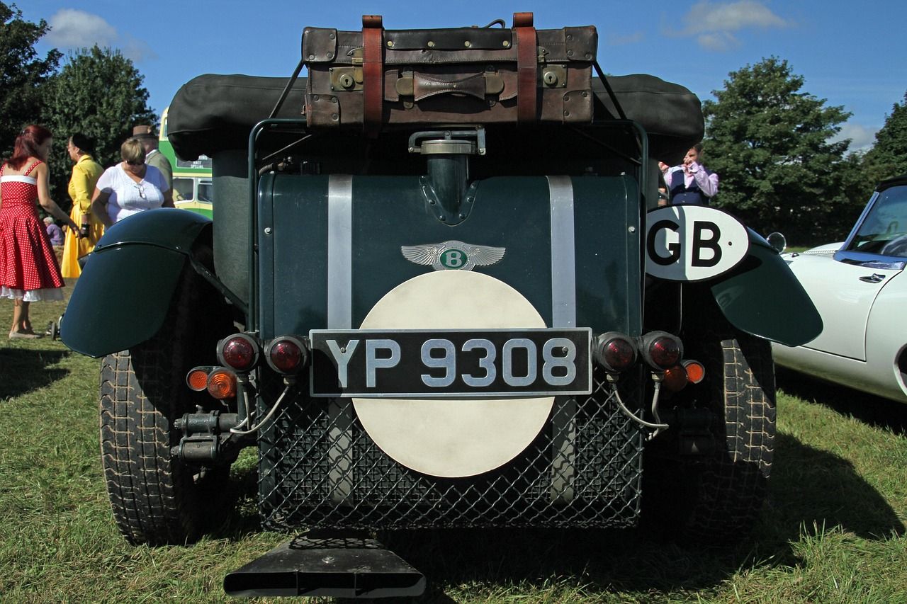Vintage vehicles in the paddock area evoking the early days of Goodwood Motor Circuit