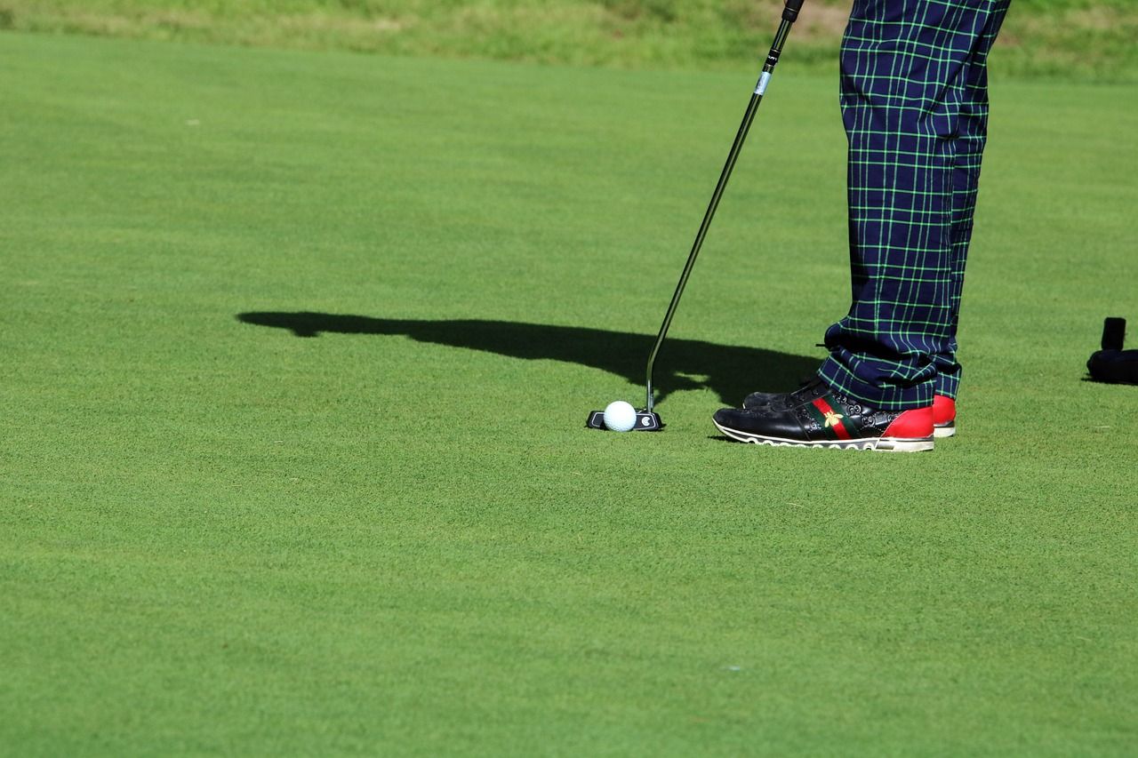 Golf tournament scene with players on the green and spectators watching