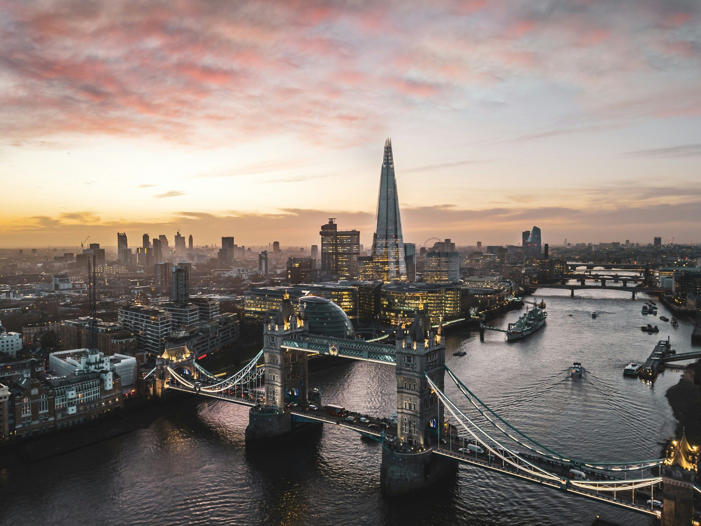 Tower Bridge, the Thames and the Shard under a pink and orange sunset