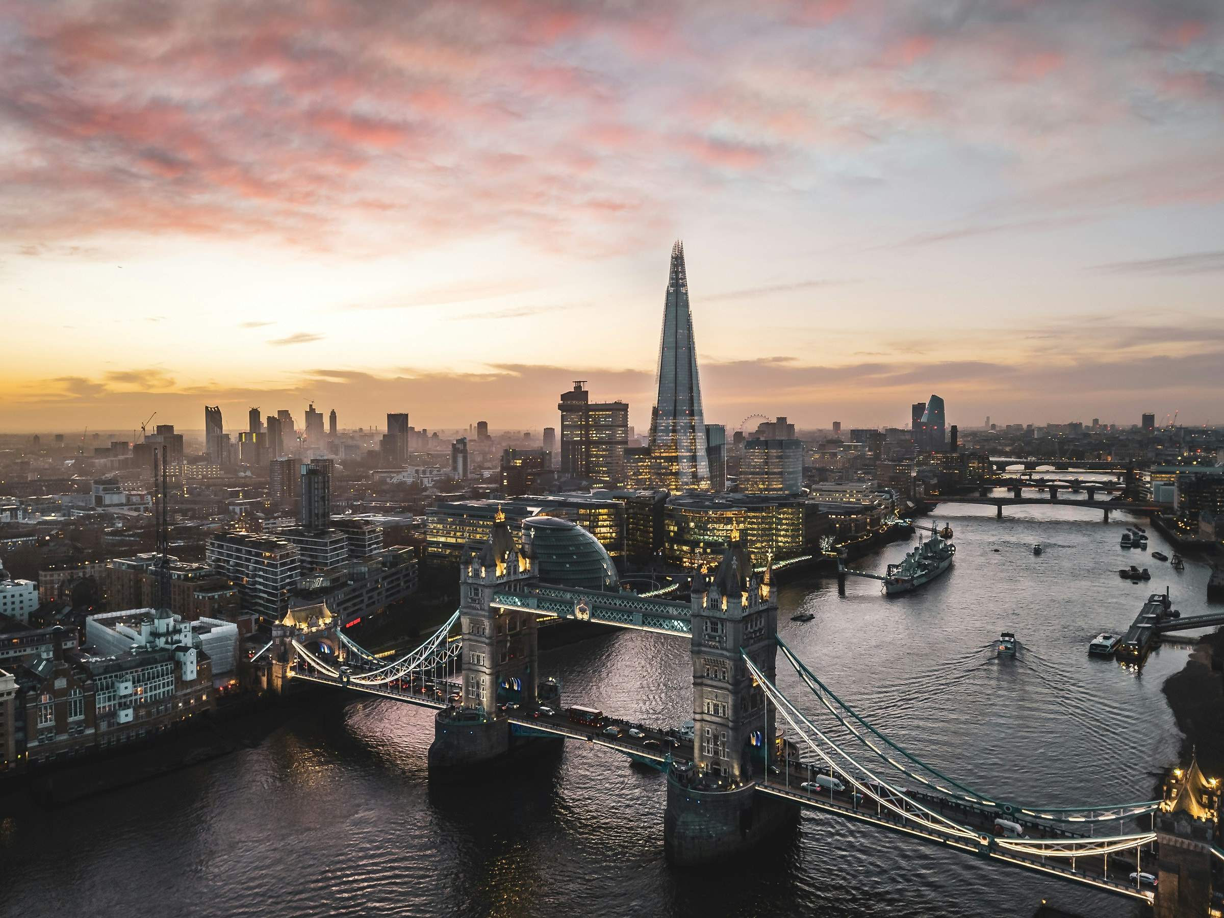 Tower Bridge, the Thames and the Shard under a pink and orange sunset