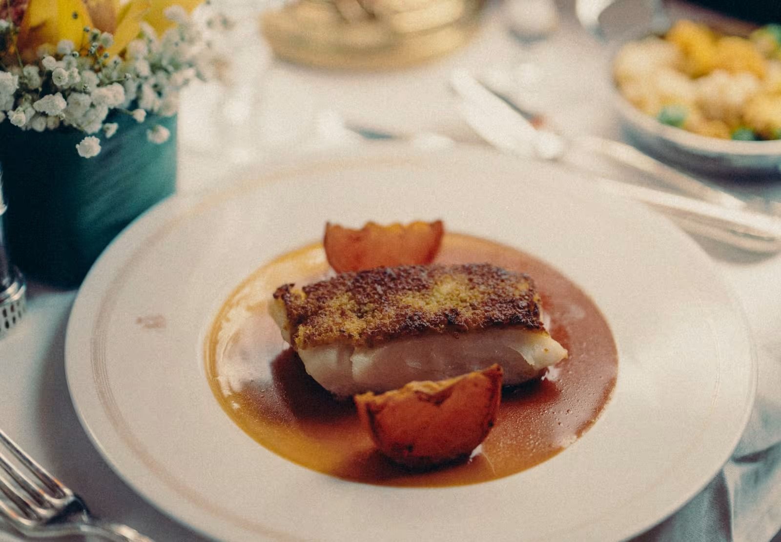 Elegant dining aboard the Venice Simplon-Orient-Express with white linen and Art Deco surroundings