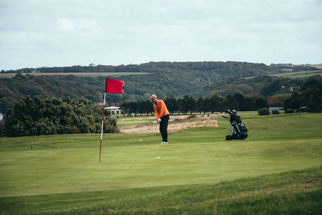 Golfer mid-swing on the tee box