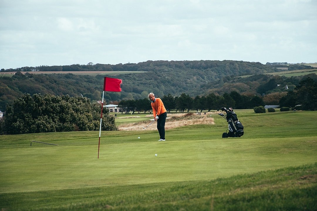 Golfer mid-swing on the tee box