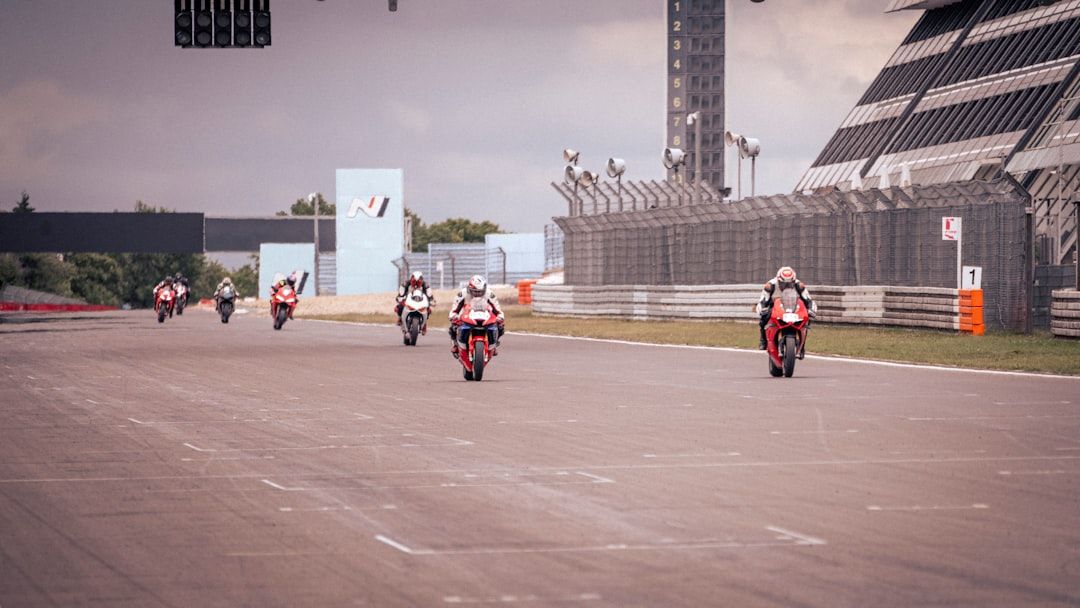 MotoGP riders racing closely on a circuit