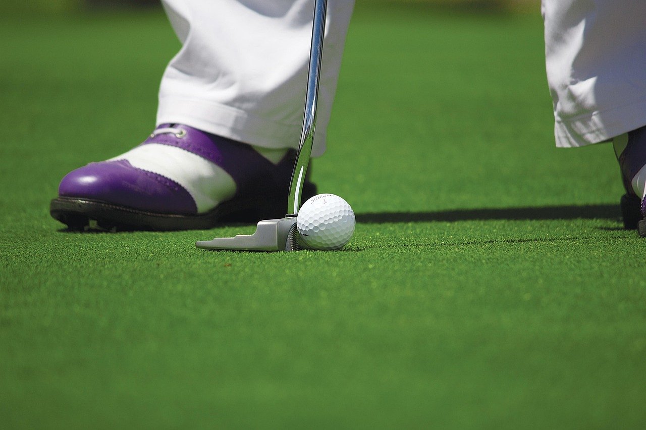 Golf ball on the putting green near the hole on a championship course
