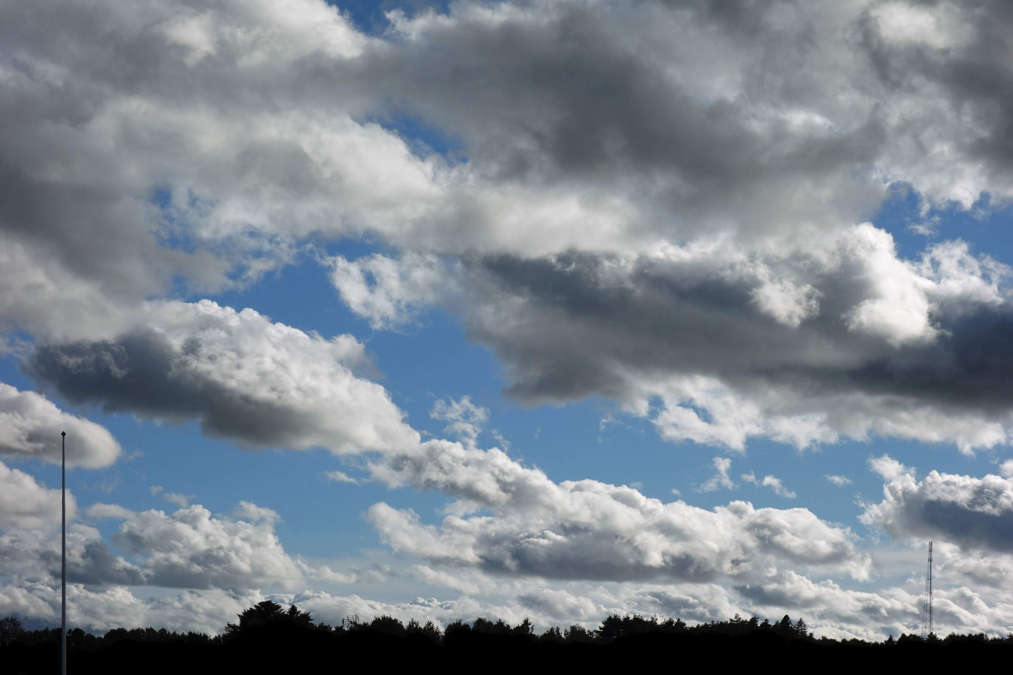 Stratocumulus and cumulus cloud formation over a wide blue sky