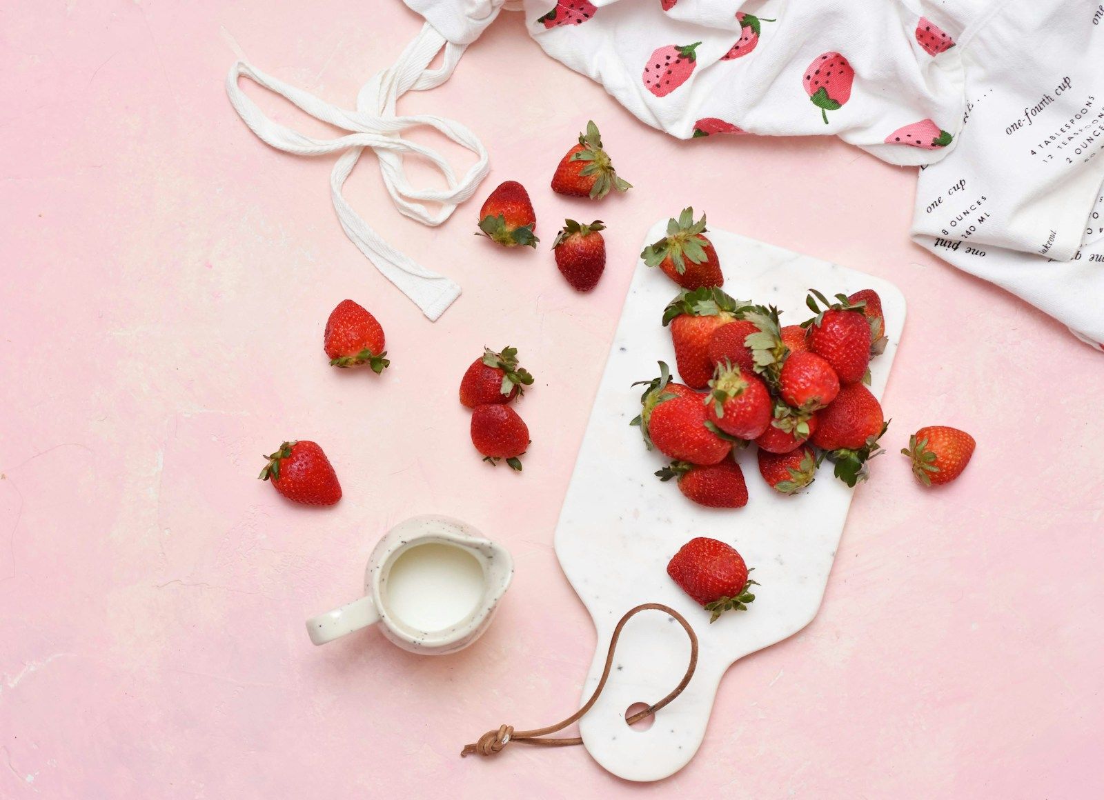 Strawberries with a swirl of cream in a small bowl