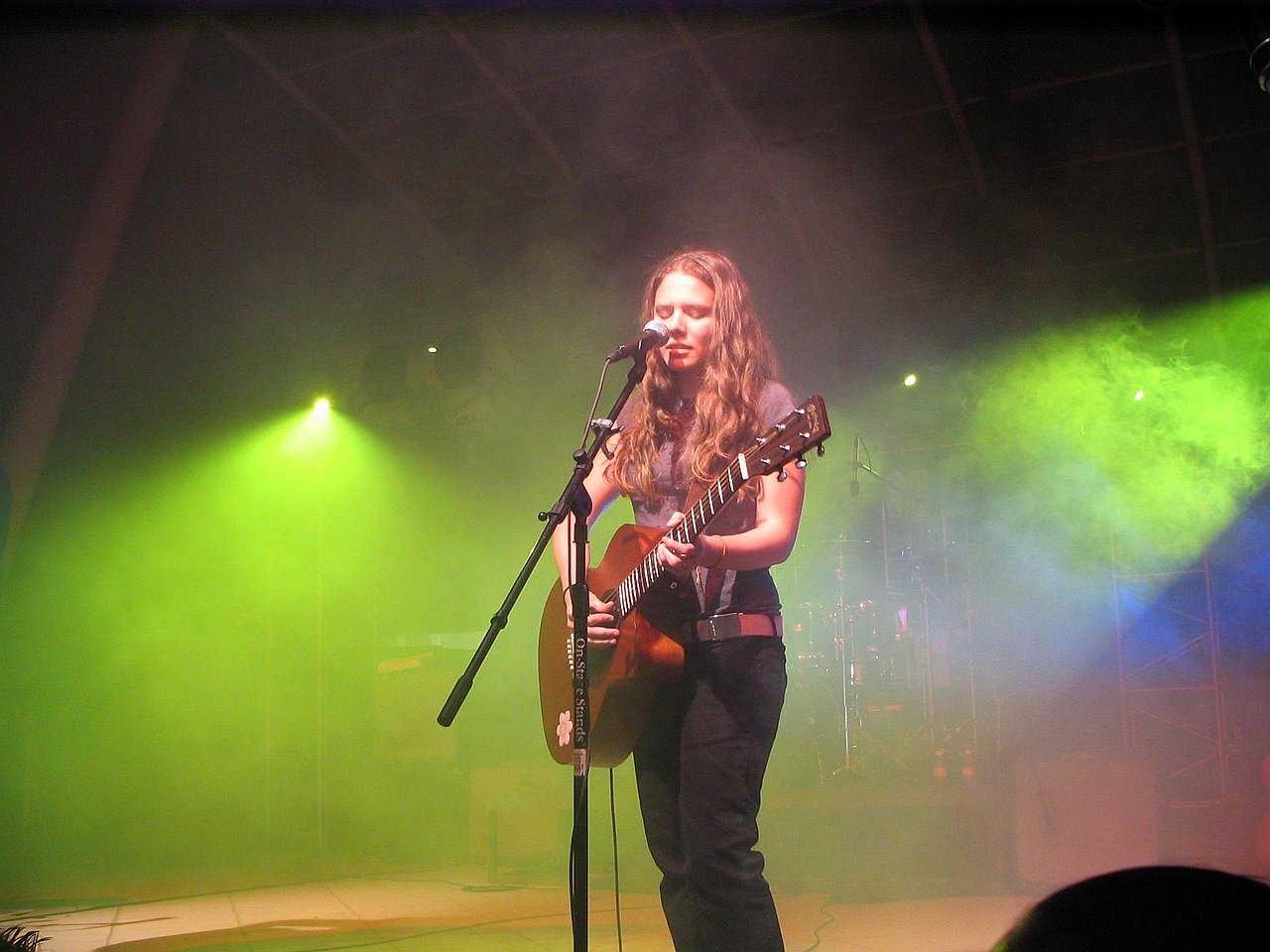 Female singer performing live on a concert stage