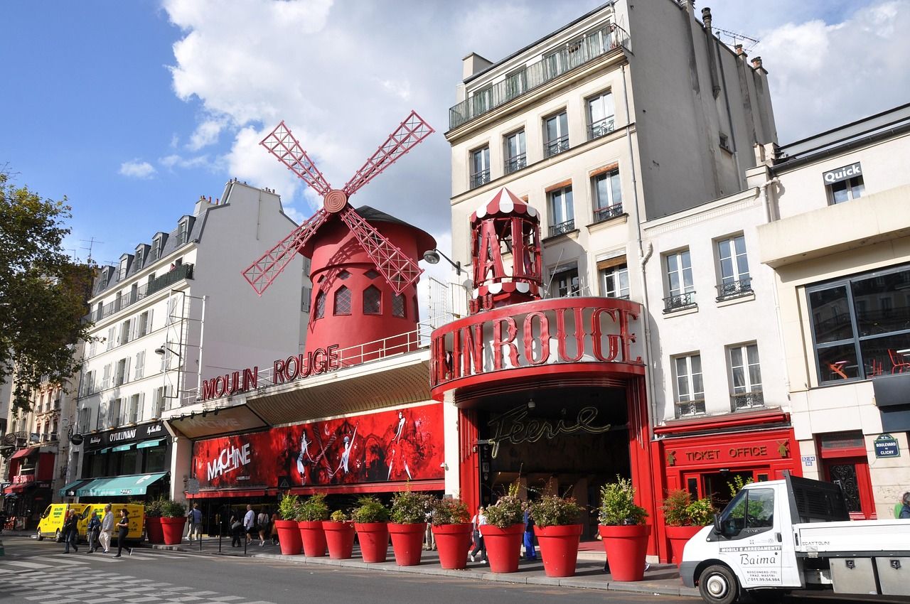 The Moulin Rouge exterior on Boulevard de Clichy in Paris with its famous red windmill