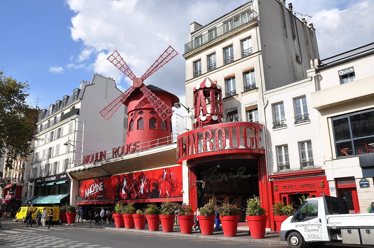 The Moulin Rouge exterior on Boulevard de Clichy in Paris with its famous red windmill