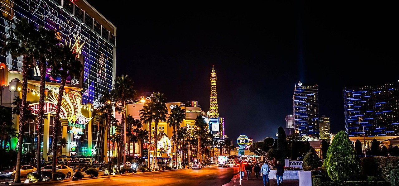 Las Vegas Strip at night with Eiffel Tower replica and casino lights
