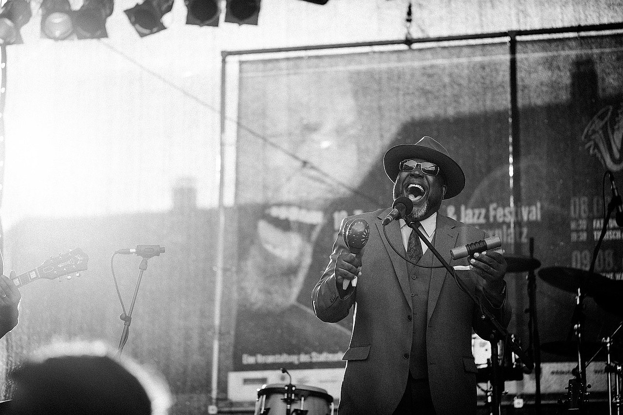 Jazz singer performing at a vintage microphone in monochrome