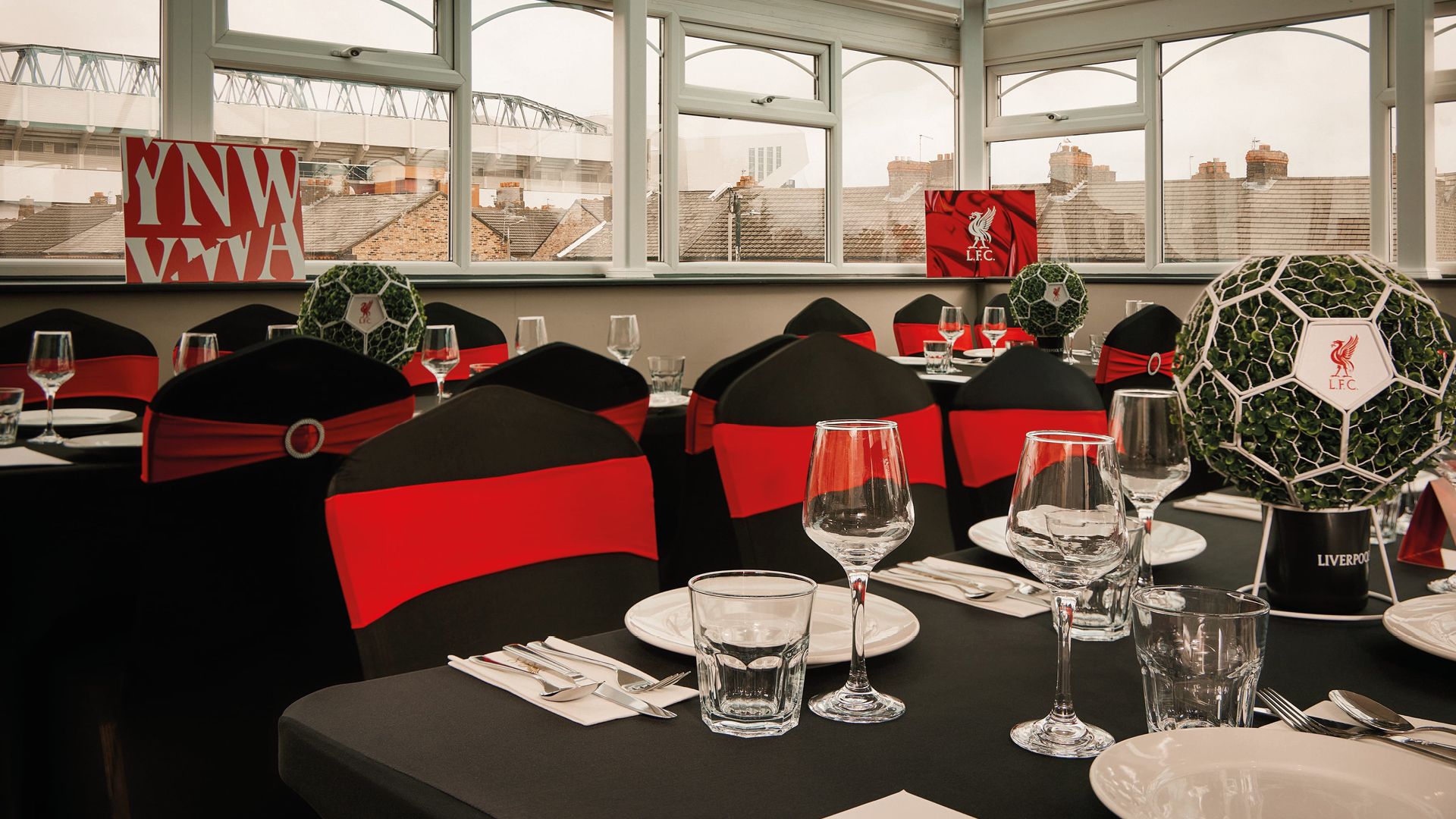 The Sandon, Anfield: The Sandon function room set for matchday dining, Anfield Main Stand visible through windows