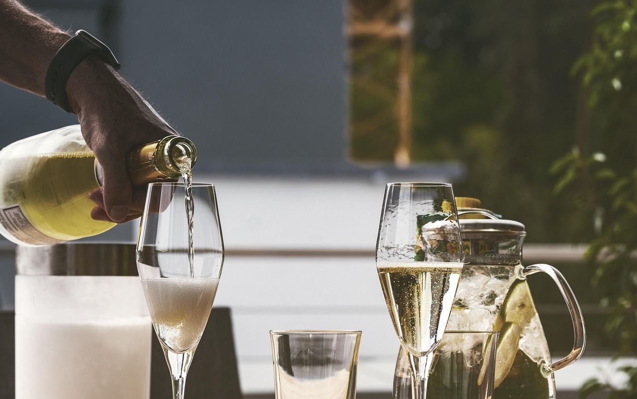 A bottle of champagne alongside a filled glass