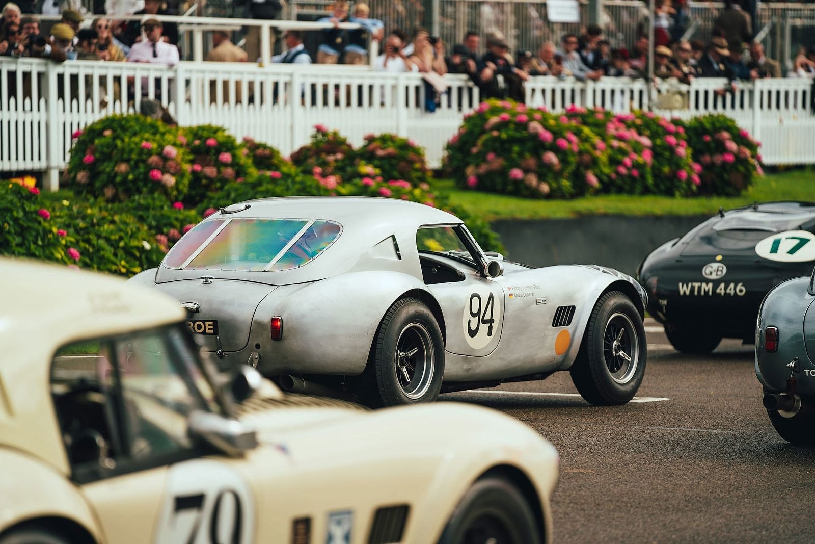 Period sports cars racing wheel to wheel at the Goodwood Revival