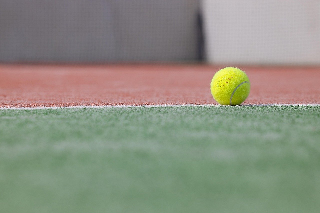 Tennis ball on a green grass court