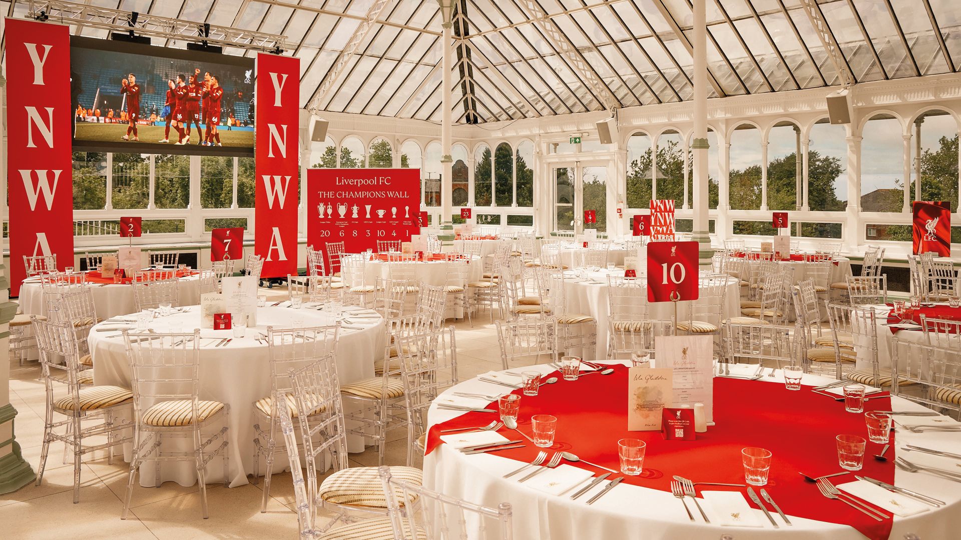 The Isla Gladstone, Anfield: Isla Gladstone Conservatory interior set for matchday dining, YNWA banners and Champions Wall