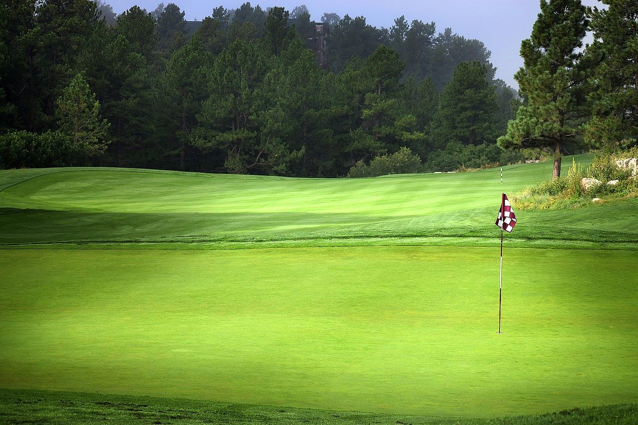 Golf course with flag on a sunny day