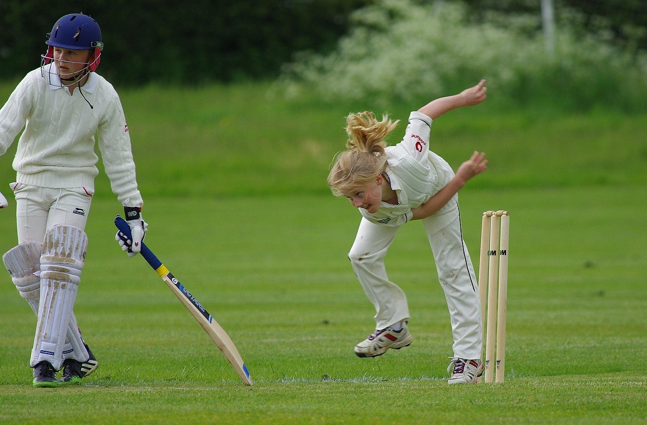 Cricket bowler in action during a match