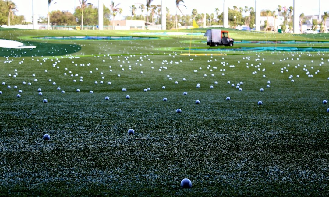 Sunlit golf course fairway with manicured greens