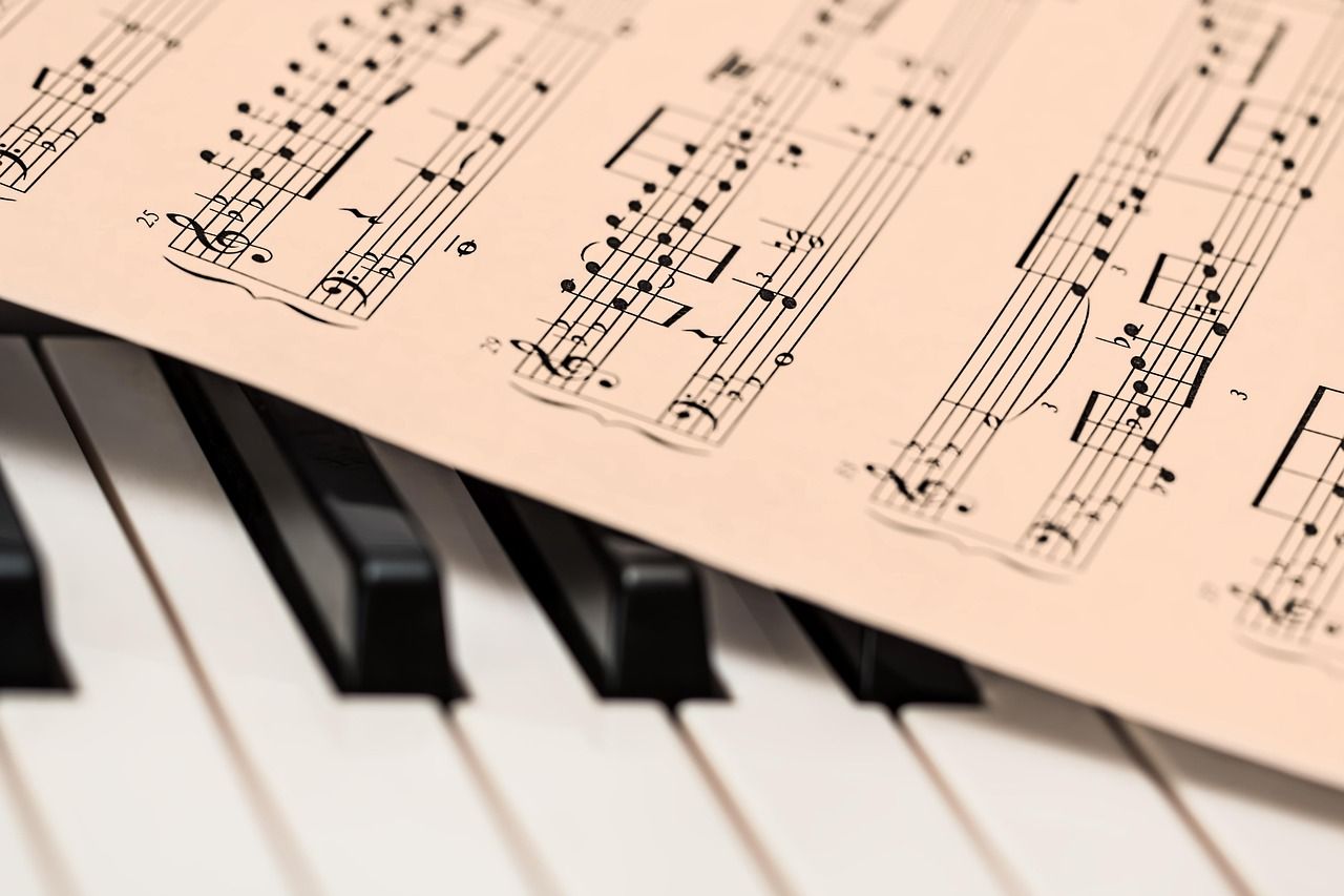 Piano keys with sheet music, representing the musical origins of Nordoff Robbins therapy
