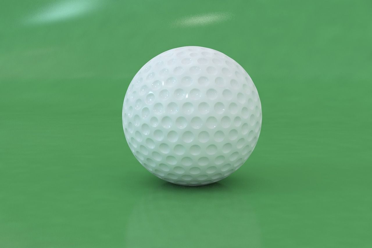 Close-up of a golf club and ball on the course